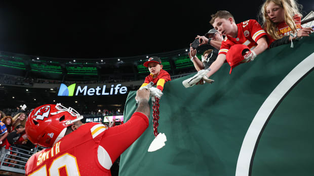 Oct 1, 2023; East Rutherford, New Jersey, USA; Kansas City Chiefs offensive tackle Donovan Smith (79) gives a glove to a young fan after the game against the New York Jets at MetLife Stadium. Mandatory Credit: Vincent Carchietta-USA TODAY Sports  